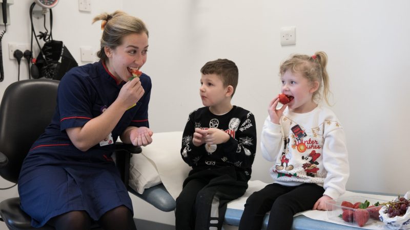 Dietician with children and fruit in cystic fibrosis clinic GNCH